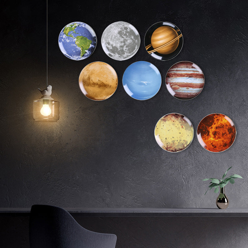 Creative wall decor: modern ceramic wall hanging featuring a space planet and astronaut design for the living room